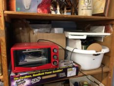 A shelf of assorted, TV, oven etc.