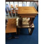 Two teak nest of tables and an occasional table