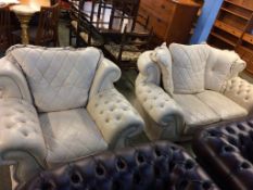An off cream/pink two seater leather sofa and armchair