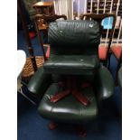 A green leather reclining armchair and footstool