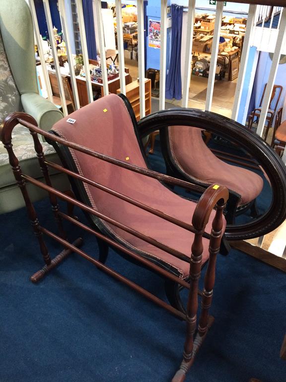 A nursing chair, mirror and a towel rail