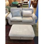 A two seater sofa and a footstool