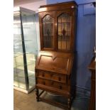 An oak leaded glass bureau bookcase