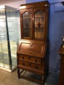 An oak leaded glass bureau bookcase