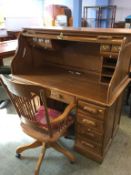 An oak roll top desk and matching chair, 137cm wide x 133cm high