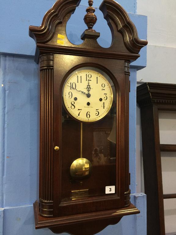 A Howard Miller mahogany wall clock