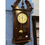 A Howard Miller mahogany wall clock