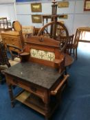 A spinning wheel, oak table and a washstand