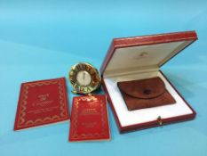 A boxed Cartier travel clock and paperwork