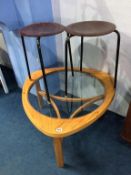 A pair of stools and a glass top coffee table