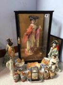 A cased Japanese doll and various figures