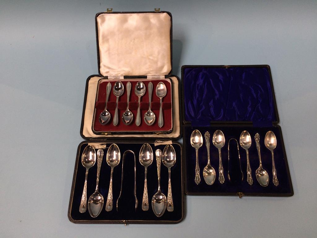 A cased set of silver spoons and two others