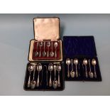 A cased set of silver spoons and two others