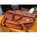 A large brown leather holdall