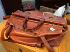 A large brown leather holdall