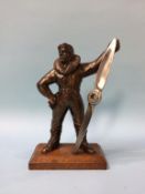 A novelty table lighter of a 1st World War pilot holding a propeller, 22cm height