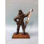 A novelty table lighter of a 1st World War pilot holding a propeller, 22cm height