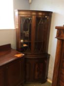 A reproduction mahogany bow front corner cabinet