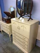 A cream tallboy and dressing chest
