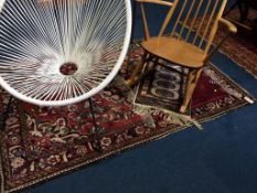 A Persian rug and two small prayer mats