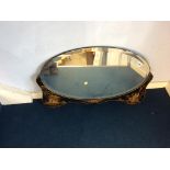 An Oriental design oval mirror