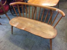 An early Ercol spindle back two seater bench