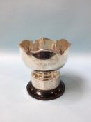 A silver bowl, London?, marks rubbed, 13oz and a decanter label
