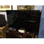 An LG 3D TV (Model number 47LM760T-ZB), with curved remote and 3D glasses