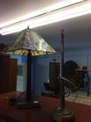 A heavy brass table lamp and a Tiffany style lamp