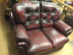 A burgundy leather two seater settee