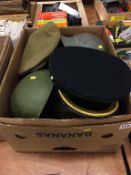 A collection of military caps and helmets