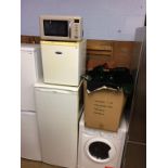 A microwave, mini freezer and Hotpoint fridge