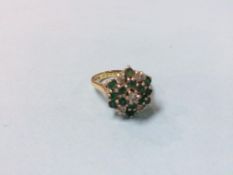 An 18ct gold ring, mounted with diamonds and emeralds, size 'O', 6.6g