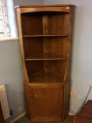 An Ercol Golden Dawn corner cabinet