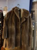 A leather and sheep wool jacket, size 38, and a Maurice Velody fur coat