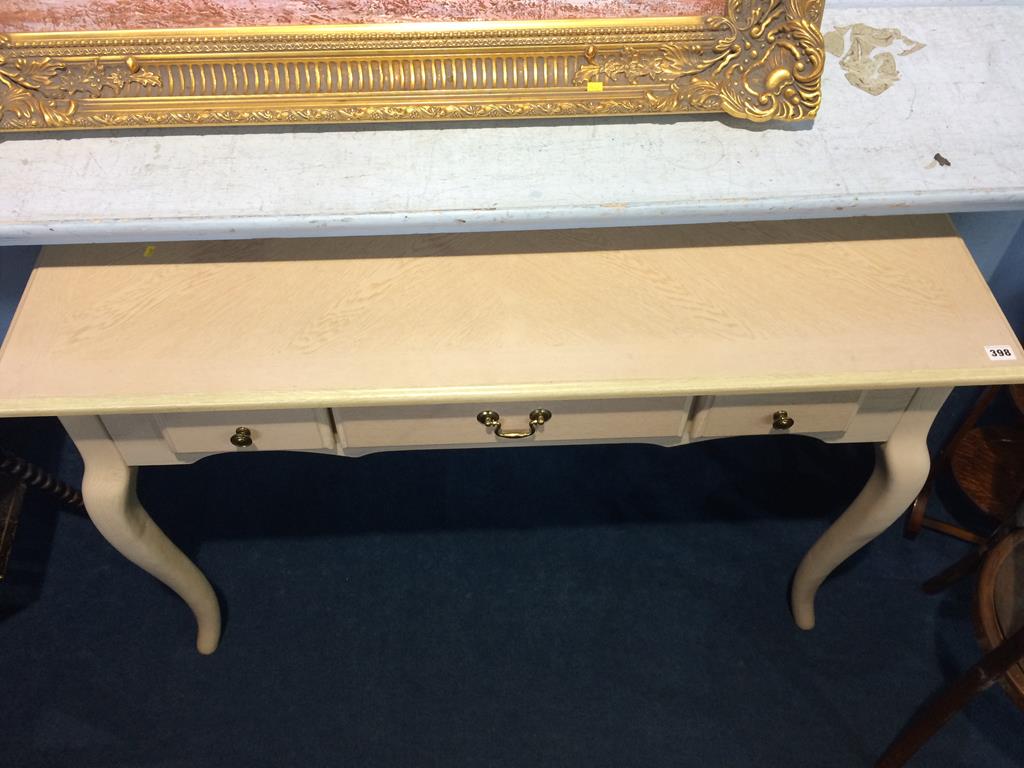 A cream three drawer side table
