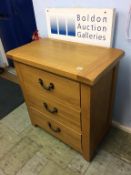 An oak three drawer chest of drawers