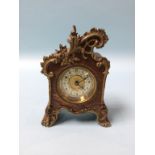 A small ornate walnut cased carriage clock, 14cm height