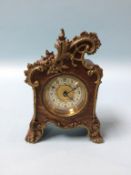 A small ornate walnut cased carriage clock, 14cm height