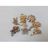 A collection of vintage costume brooches