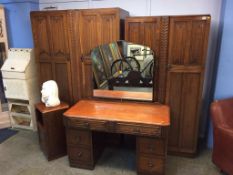 An oak linenfold bedroom suite