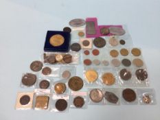 A collection of various coins and tokens, to include shop tokens, German ID tags etc.