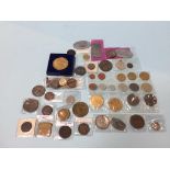 A collection of various coins and tokens, to include shop tokens, German ID tags etc.