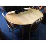 An Ercol Golden Dawn drop leaf table, with four hoop back chairs