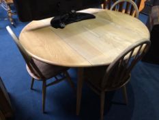 An Ercol Golden Dawn drop leaf table, with four hoop back chairs