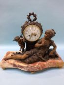 A French clock group, enamelled dial, with eight day movement, having winged angels and a