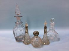 Three glass silver topped scent bottles and two decanters