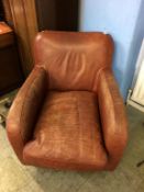 A tan brown leather armchair