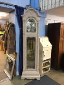 A Howard Miller modern eight day long case clock, (cost £1600), in a pale oak case