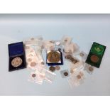 A quantity of British and European coins, a Royal Philharmonic Society medallion etc.